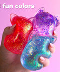 Three colorful Blue Gelli Gel Squishy Boasting Slow Flow Glitter And Iconic Shape Memory For Ultimate Stress Relief in hand.