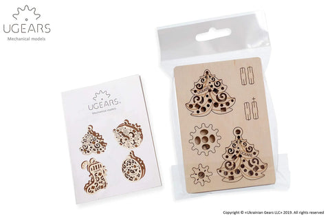 Four In One Wooden Puzzle Kit With Self Assembly Mini Mechanical Models Set Including Stocking Stuffer, Christmas Tree, Clock, And Bauble For Stress Relief, 3D Puzzles Fun For Ages 5 To 80, Plywood Construction. Plywood sheet with Christmas tree, clock, and stocking pieces