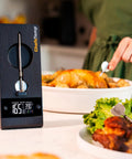 ProTemp 2 Plus Wireless Meat Thermometer With Temperature Controller next to roasted chicken and greens in kitchen