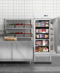 Rock Solid 27 Inch Commercial Reach In Freezer Delivers 23 Cubic Feet Of Smooth Stainless Steel Cooling With Smart Fan Chiller Plus No Sweat Digital Temp Control And Heavy Duty Roll Casters For Restaurant Setup in a kitchen with meat and frozen goods.