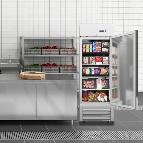 Rock Solid 27 Inch Commercial Reach In Freezer Delivers 23 Cubic Feet Of Smooth Stainless Steel Cooling With Smart Fan Chiller Plus No Sweat Digital Temp Control And Heavy Duty Roll Casters For Restaurant Setup in a kitchen with meat and frozen goods.