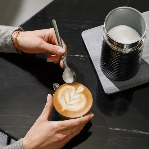 Aeroccino 3 Milk Frother For Hot Foam And Cold Froth, Easy One Step Operation, A Solid Home Coffee Setup Accessory For Lattes And Cappuccinos, Black And Steel Finish on a table