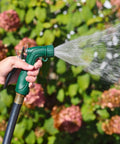 Person using Industrial Spray Nozzle With Quick Connect Set Pro Grade Adjustable Pattern From Gentle Rinse To Powerful Jet in garden.