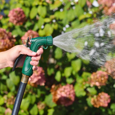 Person using Industrial Spray Nozzle With Quick Connect Set Pro Grade Adjustable Pattern From Gentle Rinse To Powerful Jet in garden.