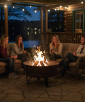 Cauldron Wood Burning Outdoor Fire Pit For Patio And Backyard Hangouts, 29-inch steel fire bowl with friends gathered around.