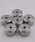 Aluminum spacers with center holes; machined silver cylindrical components