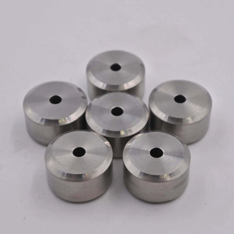 Aluminum spacers with center holes; machined silver cylindrical components