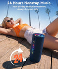Roar 3 Bass-Boosted Portable Bluetooth Speaker With 20W Thumpin Bass, JIKE Bass Enhancement, next to a woman on a beach boardwalk