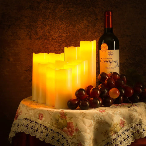 Flameless LED Pillar Candles Set Of 12 Battery Operated With Remote And Timer Real Wax Look on table with wine and grapes