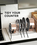 Built Tough Expandable Pan Rack With Ten Adjustable Compartments Heavy Duty Kitchen Pot Organizer displayed with pots and lids on counter.