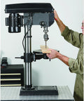 Person using 13 In Benchtop Drill Press With 3/4 HP 120V 5/8 In Chuck 1 In Drilling Capacity 16 Speeds From 220 To 3,300 RPM A Real Workhorse For Wood Plastic Metal With 45 Degree Tilt Table.