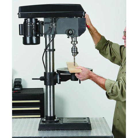 Person using 13 In Benchtop Drill Press With 3/4 HP 120V 5/8 In Chuck 1 In Drilling Capacity 16 Speeds From 220 To 3,300 RPM A Real Workhorse For Wood Plastic Metal With 45 Degree Tilt Table.