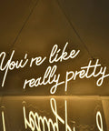 You Are Like Really Pretty White LED Neon Sign For Wall Decor 28 Inches With Dimmable Switch hanging on a wall, illuminated.