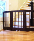 4-Panel Freestanding Pet Gate With Adjustable Wooden Panels For Doorways, Ideal For Dogs And Cats, 36 Inches Tall By 76 Inches Wide, Walnut Finish, Ready To Use Right Out Of The Box, set up in a hallway.