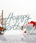 Blue Happy Birthday Neon Sign For Wall Decor With Dimmable USB Switch Reusable Neon Light For Birthday Parties Lit Vibes 17 By 12 Inch Silicone LED Strip Sign On Clear Acrylic Board against floral and ship model background.