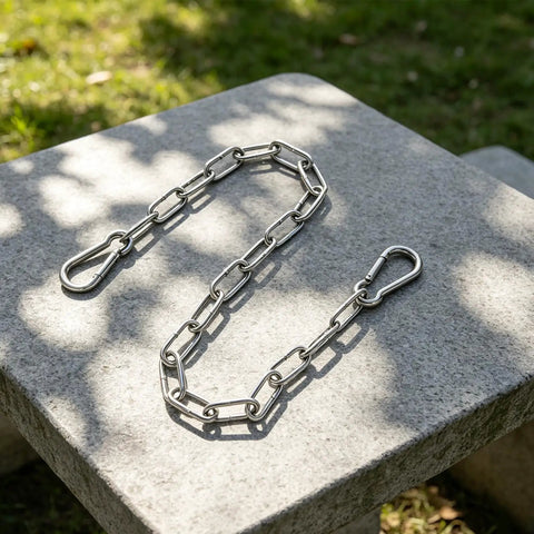 Stainless Steel Gate Chain Latch with Dual Carabiners for Fences on a stone surface, showcasing durable links.