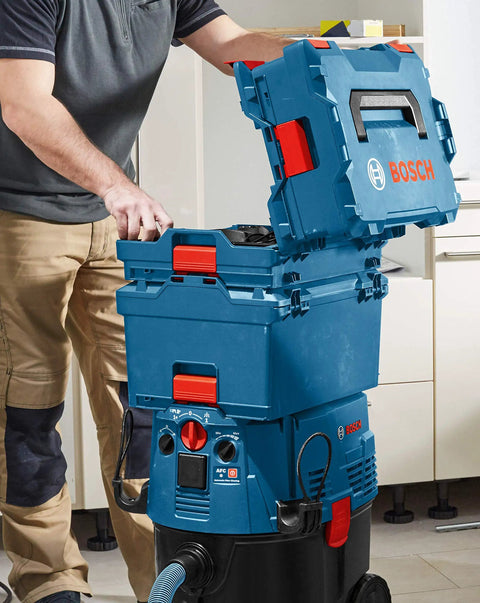Man using Stackable Tool Storage Case With 1-Click Lock, Top Front And Side Handles, Blue, 4.5 In By 14 In By 17.5 In, in workshop
