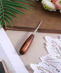 Heavy Duty Leather Working Awl, Tough As Nails Scratch Scribe For Bookbinding And Woodworking Craft Projects, Sure Grip Walnut Handle on a surface.