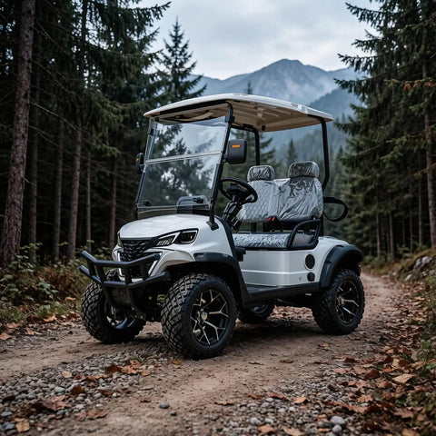 Top Shelf Two Seater Electric Golf Cart With 5kW Motor And 60V Battery Serving 20 Mph Cruising Speed Over 44 Mile Range Rock Solid Suspension And Ample Storage Built Tough For Parks Hotels Or Weekend Warriors In Crisp White parked on a dirt path in a forest.