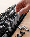 Hand organizing sockets on portable socket organizer tray holds up to eighty sockets including clips for one quarter three eighths and half inch sizes ideal for road mechanics and diyers to keep tools tidy and stop losing sockets in the toolbox.