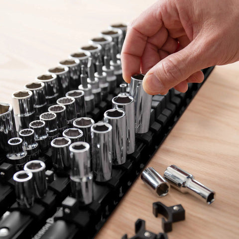 Hand organizing sockets on portable socket organizer tray holds up to eighty sockets including clips for one quarter three eighths and half inch sizes ideal for road mechanics and diyers to keep tools tidy and stop losing sockets in the toolbox.
