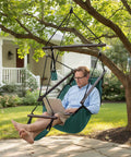Man relaxing in Upgraded Unique Hammock Hanging Sky Chair With Easy Setup Safer Design Air Deluxe Swing Seat On Durable Rope