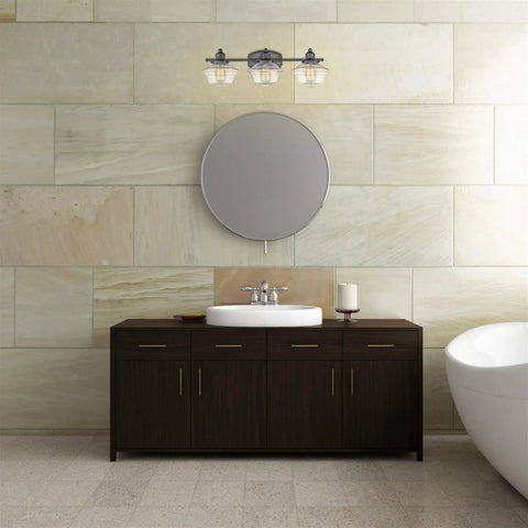 Bathroom with 26 Inch 3 Light Traditional Schoolhouse Vanity Light With Clear Glass Shades In Gray Finish above mirror.
