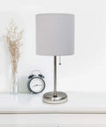 Brushed Steel Stick Table Desk Lamp With USB Charging Port And Teal Drum Fabric Shade For Modern Home Office And Living Room, Sleek Profile, Quick Plug In Lighting, Everyday Readability, Minimalist Contemporary Look on a white surface with clock and vase