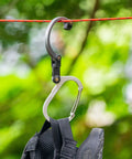 HeroClip Medium Carabiner Gear Clip And Hook For Camping Backpack And Garage Organization hanging on rope with backpack