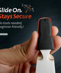 Close-up of a hand holding a black Recurve Bow Tip Protector Pack 2 Or 4, soft silicone limb guard with vent holes.