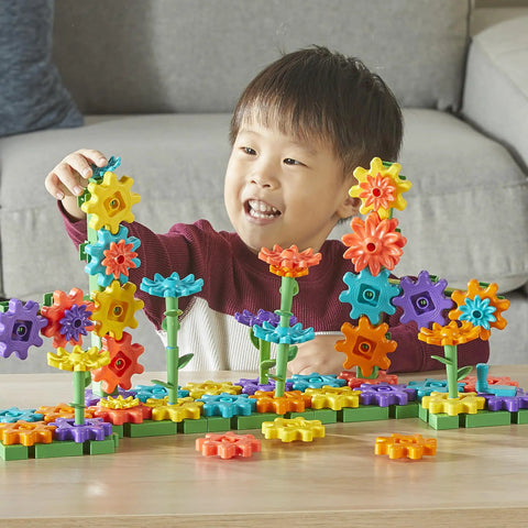 Child playing with 101 Piece Gear Building Set For Kids So They Can Build Twisting Gardens While Learning Cause Effect Sequencing And Early Engineering Hands On STEM Construction Toy Montessori Inspired Kid Friendly Fine Motor Play And Educational Engineering Gift on a table.