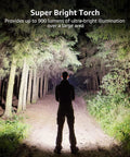 Person holding Beast Bright 900 Lumen Tactical Flashlight With Zoomable Beam illuminating forest path at night