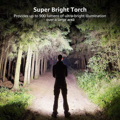 Person holding Beast Bright 900 Lumen Tactical Flashlight With Zoomable Beam illuminating forest path at night