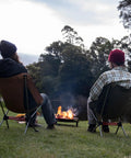 Two people sitting by a campfire on Ultralight Camping Chair For Backpacking With Anti Sink Feet Ultra Portable Folding Hiking Stool