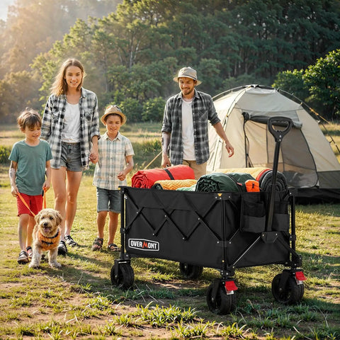 Beast Ultra Compact Folding Wagon With All-Terrain Wheels For Beach Trips Grocery Runs Camping And Gardening Heavy Duty 360 Lb Load Capacity Portable Black Cart in use at a campsite, loaded with gear, with a tent and family nearby.