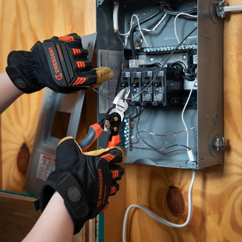 An electrician uses 8 Inch Pro Series Diagonal Cutting Pliers With Dual Material Grips to cut wire in a circuit breaker box.