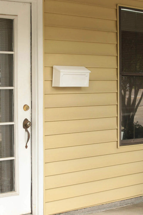 Windsor Small Capacity Rust Proof White Plastic Wall Mount Mailbox on porch, lightweight and durable, ample space for letters
