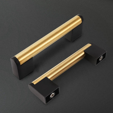 Gold And Black Cabinet Handles Pack Of 10 Slick Brushed Brass Look Drawer Pulls For Kitchen Bath And Bedroom Furniture Three And Three Quarters Inch Hole Centers 96 mm Durable Zinc Alloy With Stainless Steel Tube Core shown at an angle on a black background. Product highlighted with focus on design and finish.