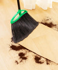 Heckin Tough Heavy Duty Brooms Two Pack With 55 Inch Long Handles Angled Head cleaning up coffee grounds on wood floor.
