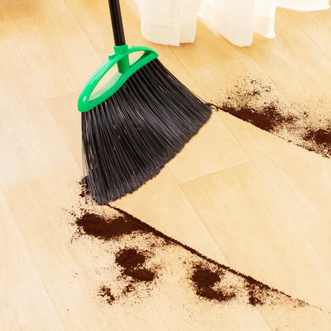 Heckin Tough Heavy Duty Brooms Two Pack With 55 Inch Long Handles Angled Head cleaning up coffee grounds on wood floor.