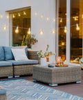 29 Feet LED Outdoor String Lights With Shatterproof G40 Edison Bulbs illuminating a cozy backyard patio with wicker furniture.