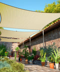 Beige 10x16 Rectangle Sun Shade Sail Canopy with water permeable fabric UV block up to 95 percent over a patio garden area