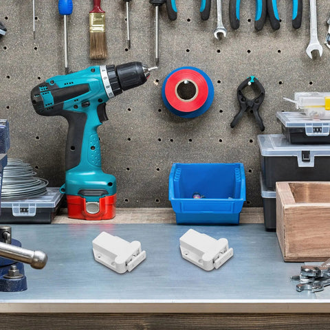 8 Pack No Fuss Self Closing Cabinet Latches with push button on a workshop table with tools and storage boxes in the background.