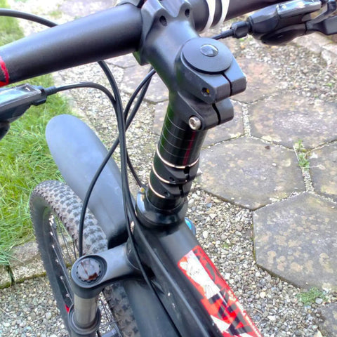 Close-up of bike with Bike Fork Stem Extender And Handlebar Riser Adaptor Aluminum Alloy Head Up Adapter installed.