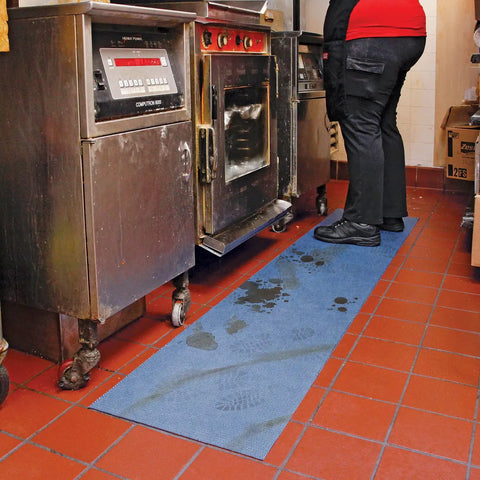 Industrial kitchen showing blue "Adhesive-Backed Absorbent Mat For Industrial Floors, Grippy Surface That Stays Put, 16 W X 25 Ft L" in use