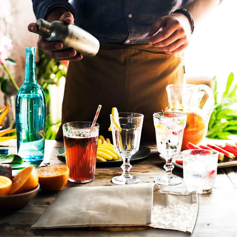 Heavy Duty Canvas Lewis Ice Crushing Bags 2 Pack Bartender Gear with cocktails and drinks on a wooden table.