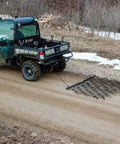 Rugged 6 Foot By 4 Foot Tow Behind Drag Harrow With Powder Coat Black Finish for gardens attached to an ATV on a path