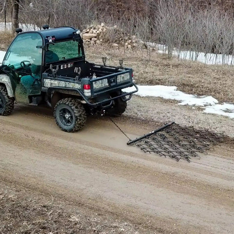 Rugged 6 Foot By 4 Foot Tow Behind Drag Harrow With Powder Coat Black Finish for gardens attached to an ATV on a path
