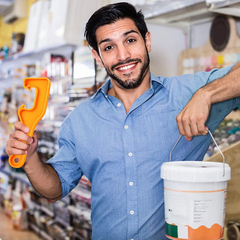 Person holding orange opener from 4 Pack Plastic Bucket Lid Openers For 5 Gallon Paint Cans Easy Lid Remover Wrench Tool For Home Garage Or Shop Use No Fuss Quick Pop Durable And Handy Heavy Duty Plastic