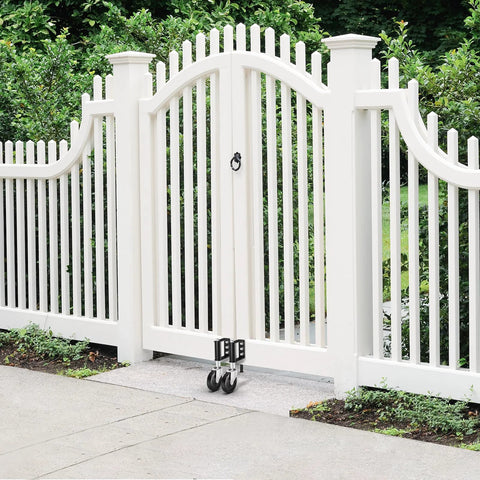 Hidden Spring Gate Wheels For Wooden Gates Heavy Duty Gate Casters With Spring Loaded Shock Absorber 4 Inch Black Wheels Supports Up To 220 Lbs Quiet Smooth Operation On Rocky Driveways And Uneven Terrain For Farm Fences attached to a white gate.